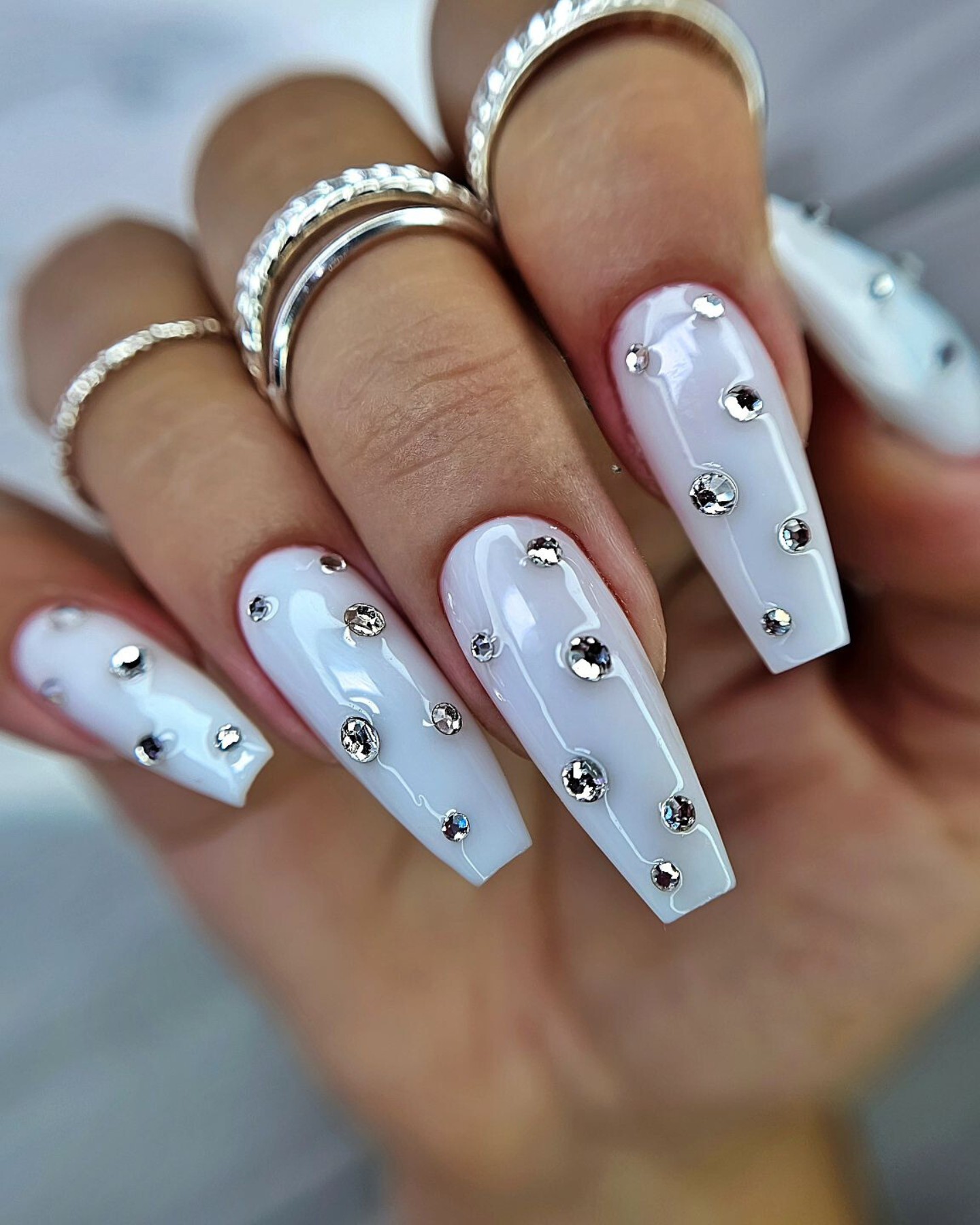 Chic White Nails with Silver Embellishments