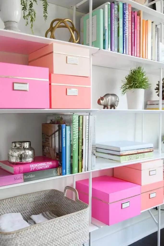 Color Coordinated Storage Boxes On A Bookshelf