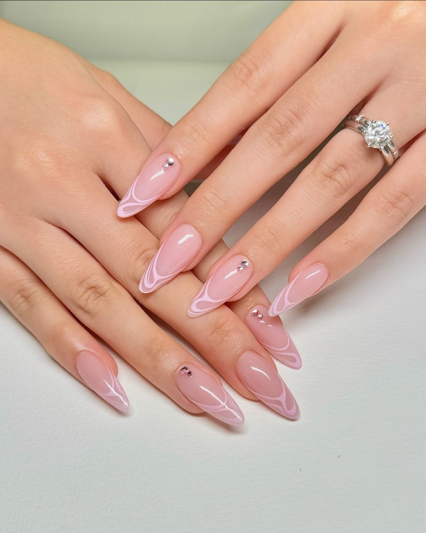 Chic Pink Almond Nails with White Swirls