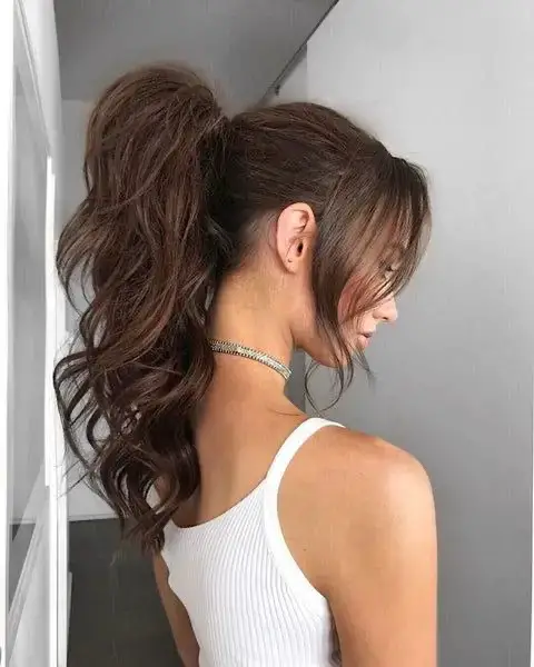 Curly High Ponytail with Loose Curtain Bangs